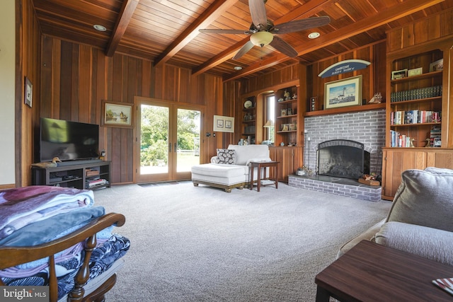 5509 Waterview Dr, Cambridge, MD 21613 - living area with wooden walls, wooden ceiling with exposed beams, carpet flooring, a fireplace, and a ceiling fan