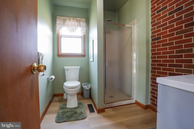 5509 Waterview Dr, Cambridge, MD 21613 - bathroom featuring a stall shower, toilet, wood finished floors, and baseboards