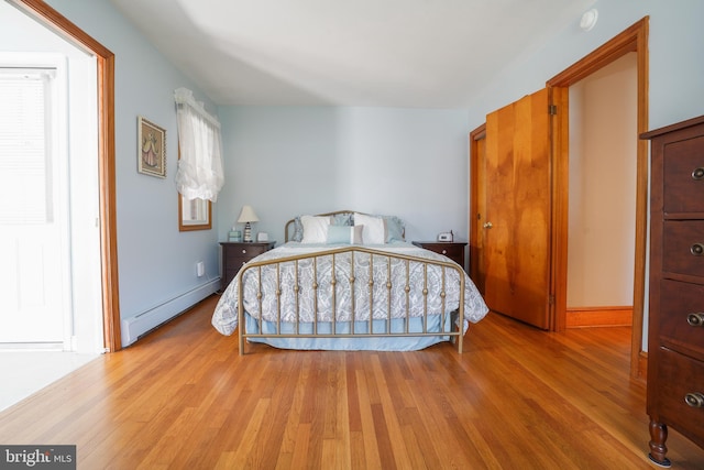 5509 Waterview Dr, Cambridge, MD 21613 - bedroom with a baseboard radiator, light wood-type flooring, and baseboards