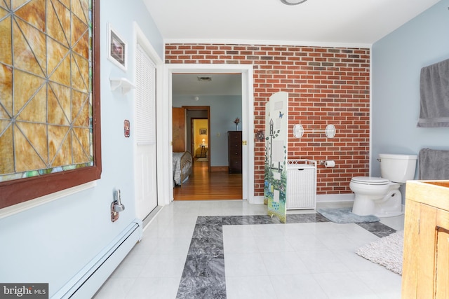 5509 Waterview Dr, Cambridge, MD 21613 - bathroom with brick wall, toilet, a baseboard radiator, vanity, and radiator