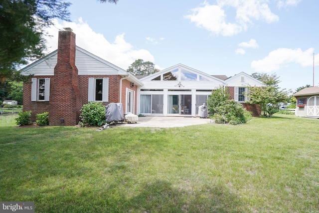 5509 Waterview Dr, Cambridge, MD 21613 - rear view of house featuring brick siding, a patio, a chimney, and a lawn