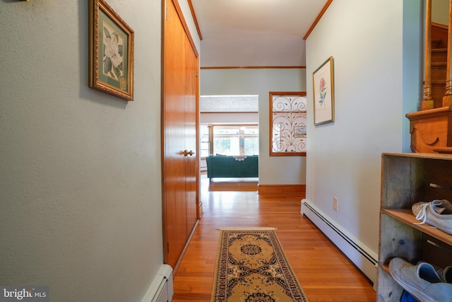 5509 Waterview Dr, Cambridge, MD 21613 - corridor with a baseboard heating unit, crown molding, light wood-type flooring, and baseboards