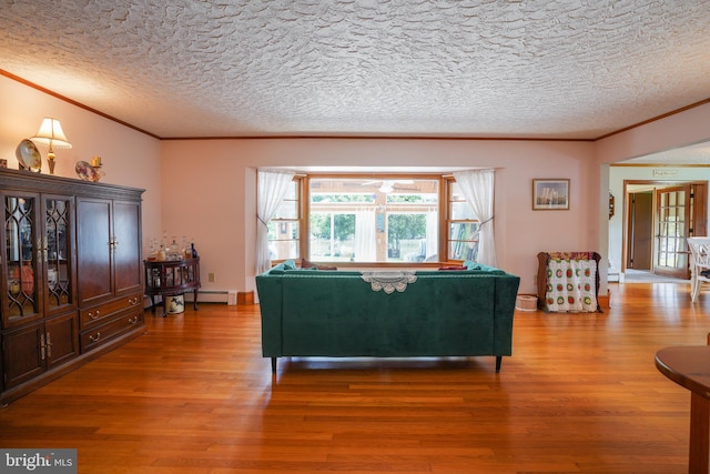 5509 Waterview Dr, Cambridge, MD 21613 - living area featuring ornamental molding, wood finished floors, a baseboard radiator, and a textured ceiling