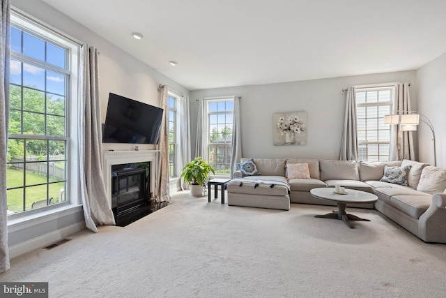 42735 Macauley Pl, Ashburn, VA 20148 - carpeted living room with plenty of natural light, a premium fireplace, and baseboards