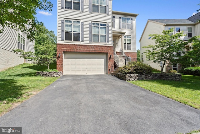 42735 Macauley Pl, Ashburn, VA 20148 - view of property with brick siding, driveway, a garage, and a front yard