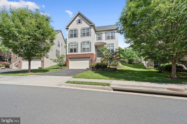 42735 Macauley Pl, Ashburn, VA 20148 - view of property featuring driveway, an attached garage, brick siding, a front yard, and board and batten siding