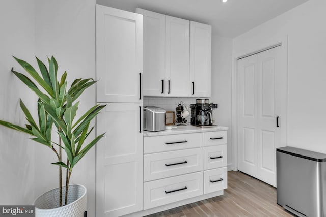 1328 Cox Cv, Stoney Beach, MD 21226 - kitchen featuring stainless steel fridge, white cabinetry, light wood finished floors, and light countertops