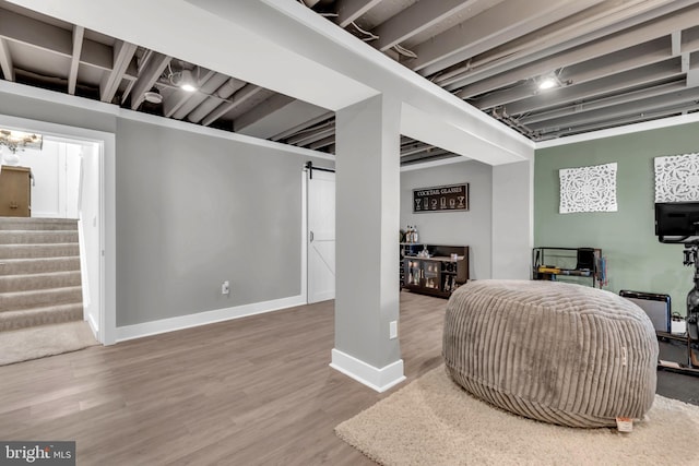1328 Cox Cv, Stoney Beach, MD 21226 - living room with stairway, wood finished floors, baseboards, and a barn door