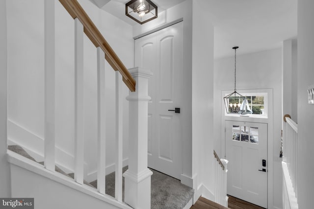 1328 Cox Cv, Stoney Beach, MD 21226 - foyer with a chandelier, baseboards, wood finished floors, and stairway