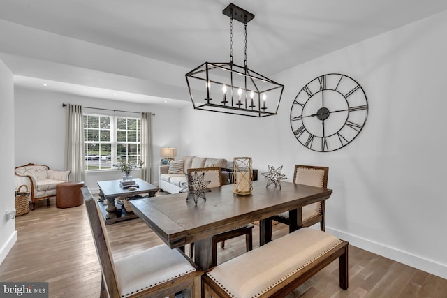 1328 Cox Cv, Stoney Beach, MD 21226 - dining area featuring wood finished floors, baseboards, and a chandelier
