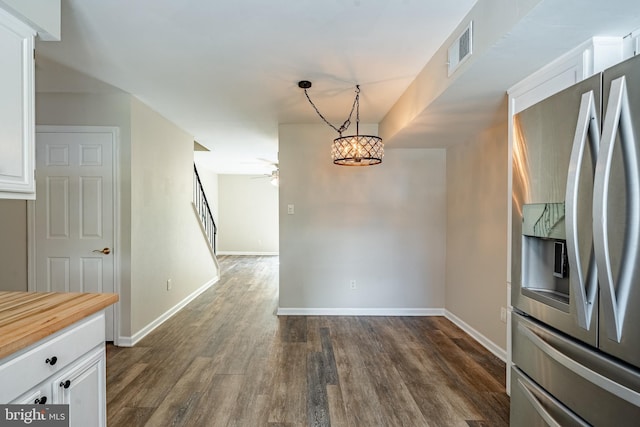2806 Eagle Rd Unit 2806, West Chester, PA 19382 - unfurnished dining area featuring dark wood-style flooring, baseboards, ceiling fan, and stairs