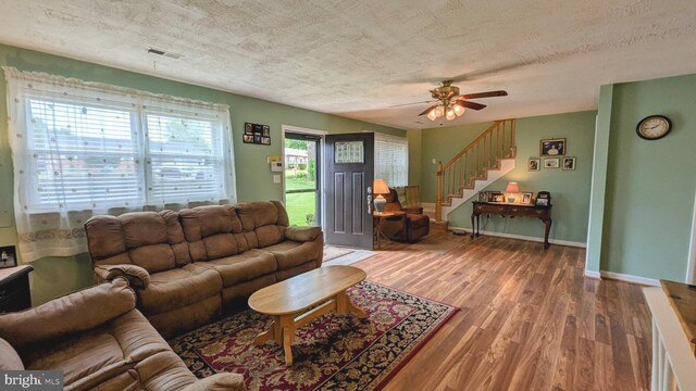 12 Rogers Cir, Newark, DE 19702 - living area with stairway, a textured ceiling, wood finished floors, baseboards, and ceiling fan