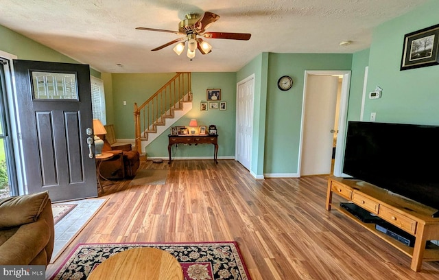 12 Rogers Cir, Newark, DE 19702 - entryway with wood finished floors, stairway, ceiling fan, baseboards, and a textured ceiling