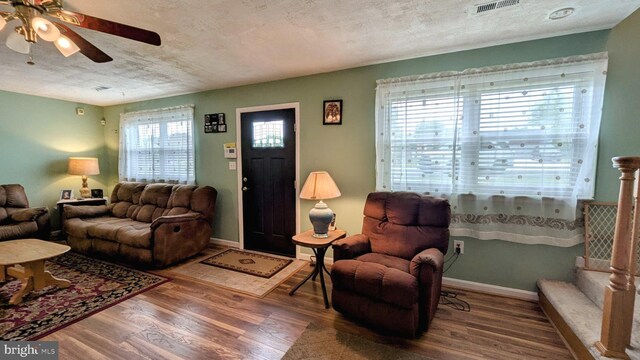 12 Rogers Cir, Newark, DE 19702 - living area featuring wood finished floors, a ceiling fan, baseboards, and a textured ceiling