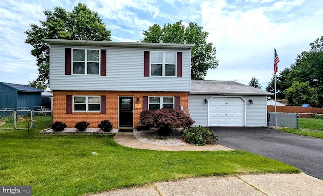 12 Rogers Cir, Newark, DE 19702 - colonial house featuring a garage, driveway, brick siding, and a gate