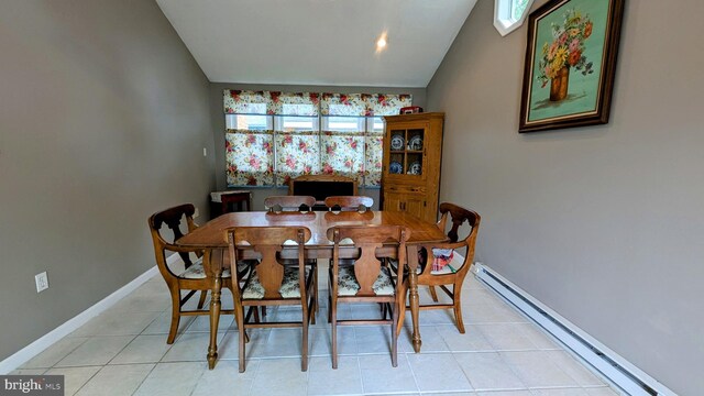 12 Rogers Cir, Newark, DE 19702 - dining area with a baseboard radiator, light tile patterned floors, vaulted ceiling, and baseboards