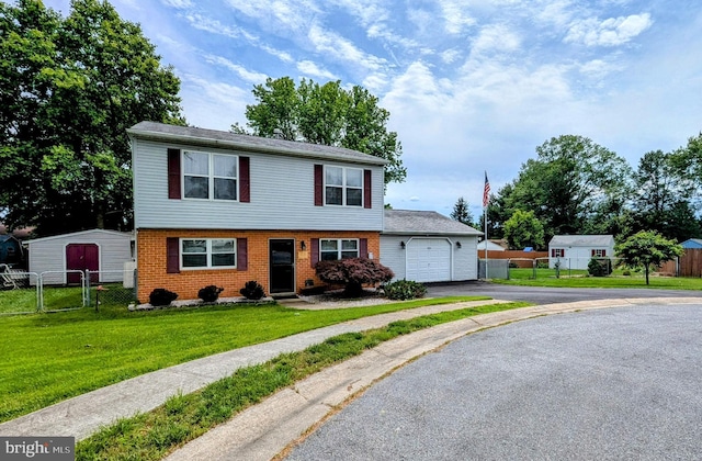 12 Rogers Cir, Newark, DE 19702 - view of front of home featuring asphalt driveway, a garage, a gate, and brick siding