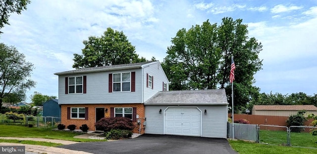 12 Rogers Cir, Newark, DE 19702 - view of front facade featuring a garage, asphalt driveway, and brick siding