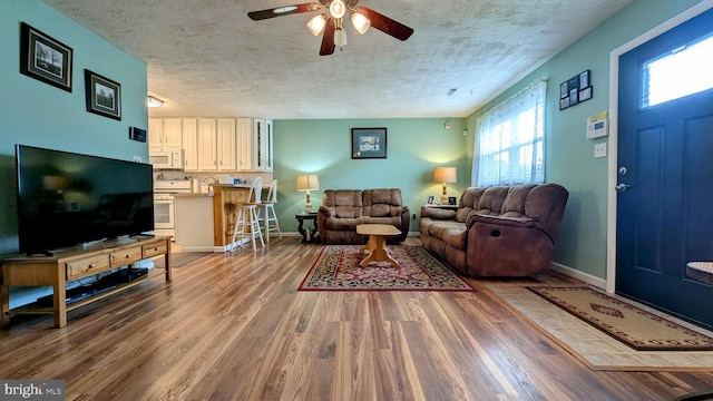 12 Rogers Cir, Newark, DE 19702 - living room with a ceiling fan, wood finished floors, a textured ceiling, and baseboards