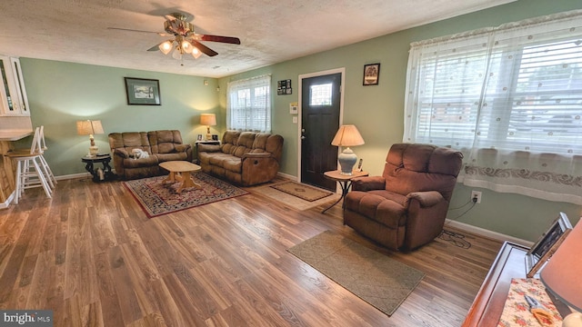 12 Rogers Cir, Newark, DE 19702 - living room with wood finished floors, a ceiling fan, baseboards, and a textured ceiling