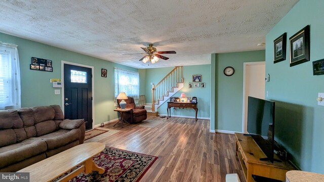 12 Rogers Cir, Newark, DE 19702 - living area featuring stairway, a textured ceiling, wood finished floors, ceiling fan, and baseboards