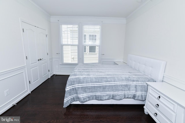 42344 Abney Wood Dr, Chantilly, VA 20152 - bedroom featuring multiple windows, ornamental molding, dark wood-style floors, wainscoting, and a closet