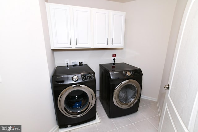 42344 Abney Wood Dr, Chantilly, VA 20152 - laundry area with washing machine and dryer, cabinet space, light tile patterned flooring, and baseboards