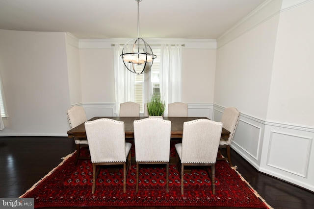 42344 Abney Wood Dr, Chantilly, VA 20152 - dining room featuring dark wood-style floors, a wainscoted wall, a chandelier, a decorative wall, and ornamental molding