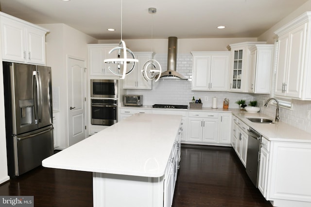 42344 Abney Wood Dr, Chantilly, VA 20152 - kitchen with stainless steel appliances, wall chimney exhaust hood, a sink, white cabinets, and recessed lighting