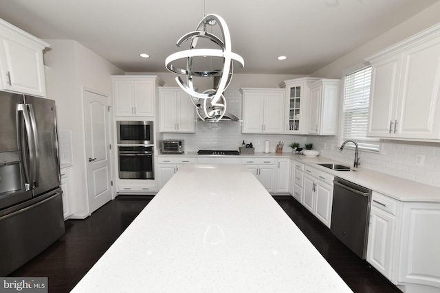 42344 Abney Wood Dr, Chantilly, VA 20152 - kitchen featuring appliances with stainless steel finishes, a sink, a chandelier, white cabinetry, and recessed lighting
