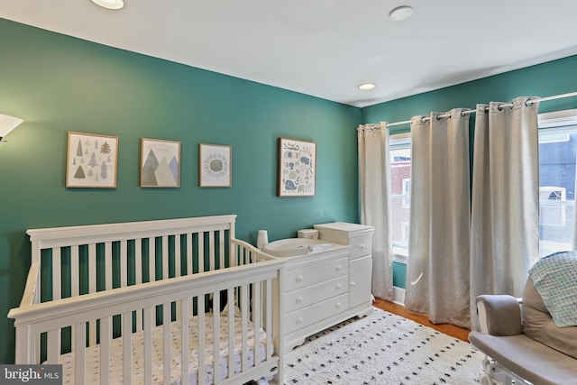 1201 Cooksie St, Baltimore, MD 21230 - bedroom featuring a crib and wood finished floors