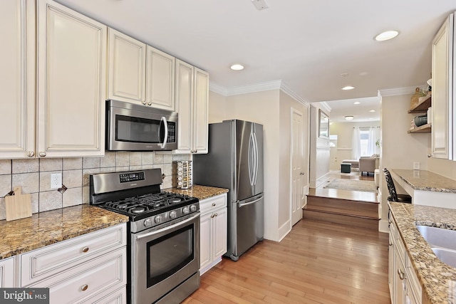 1201 Cooksie St, Baltimore, MD 21230 - kitchen with appliances with stainless steel finishes, light wood finished floors, crown molding, decorative backsplash, and recessed lighting