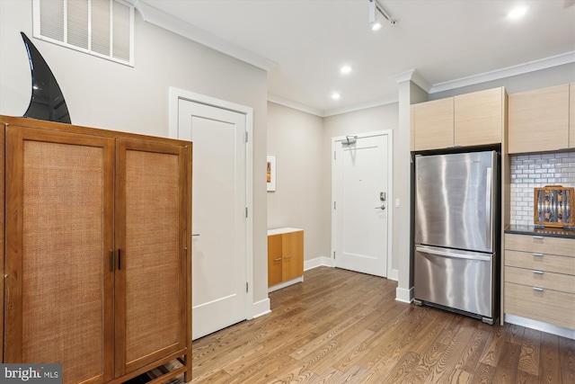 510 Diamondback Dr Unit 469, Gaithersburg, MD 20878 - kitchen with freestanding refrigerator, crown molding, wood finished floors, and baseboards