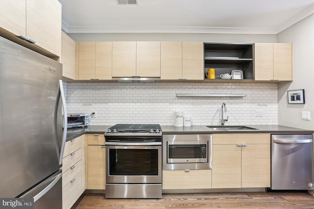 510 Diamondback Dr Unit 469, Gaithersburg, MD 20878 - kitchen featuring appliances with stainless steel finishes, crown molding, under cabinet range hood, a sink, and light brown cabinets