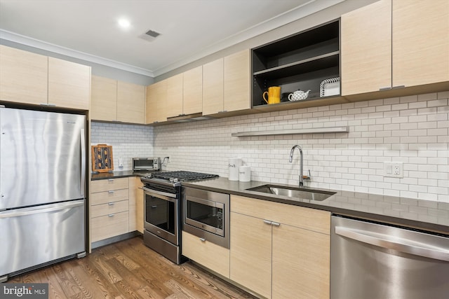 510 Diamondback Dr Unit 469, Gaithersburg, MD 20878 - kitchen featuring stainless steel appliances, a sink, ornamental molding, light brown cabinetry, and dark countertops