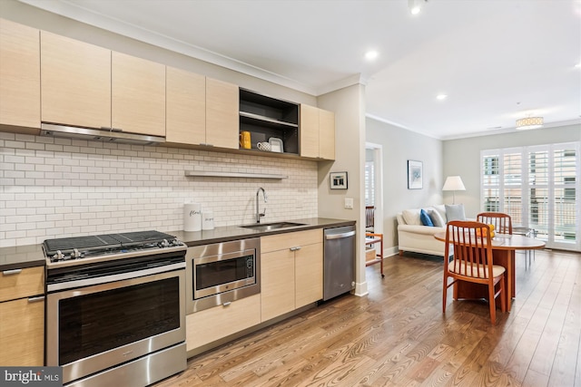 510 Diamondback Dr Unit 469, Gaithersburg, MD 20878 - kitchen featuring stainless steel appliances, a sink, ventilation hood, dark countertops, and crown molding