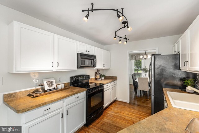 11 Basalt Dr, Fredericksburg, VA 22406 - kitchen featuring black appliances, light wood finished floors, a chandelier, and white cabinets