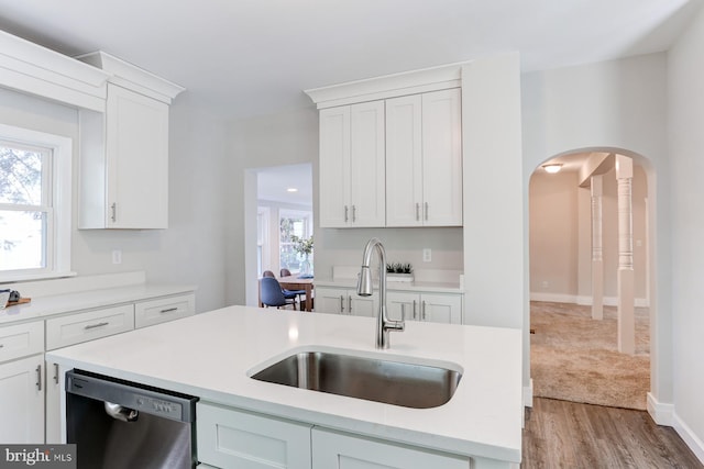267 S 12th St, Lebanon, PA 17042 - kitchen with stainless steel dishwasher, a sink, arched walkways, and light countertops