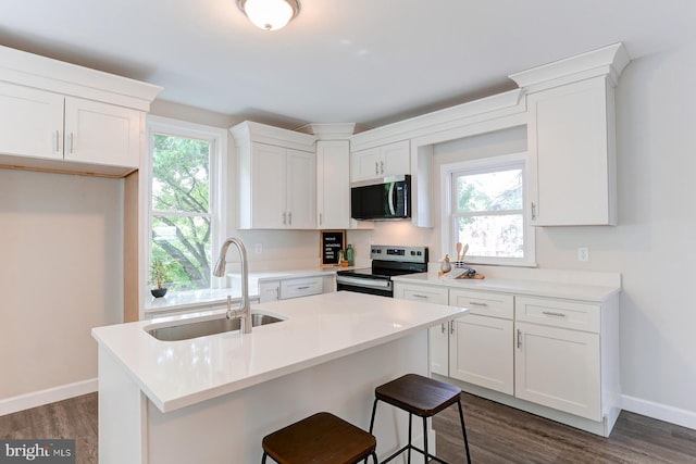 267 S 12th St, Lebanon, PA 17042 - kitchen featuring stainless steel appliances, a sink, dark wood-type flooring, baseboards, and white cabinets