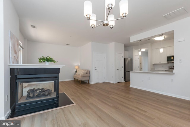 1859 Cedar Cove Way Unit 201, Woodbridge, VA 22191 - living area with light wood-style floors, a chandelier, and baseboards