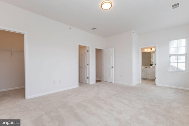 1859 Cedar Cove Way Unit 201, Woodbridge, VA 22191 - unfurnished bedroom with a spacious closet, light colored carpet, baseboards, a closet, and ensuite bathroom