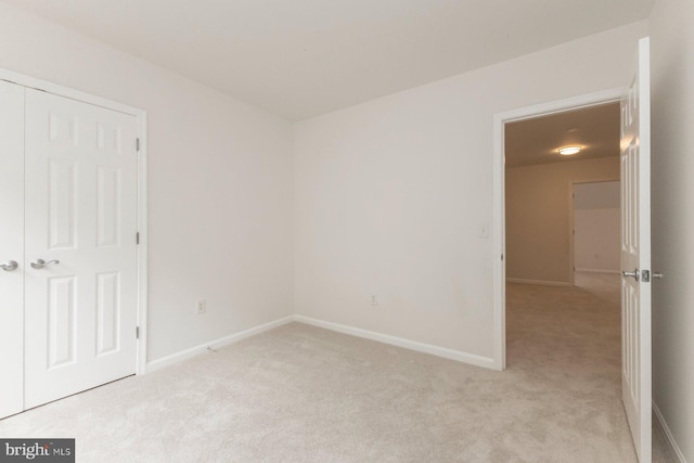 1859 Cedar Cove Way Unit 201, Woodbridge, VA 22191 - unfurnished bedroom with light colored carpet, baseboards, and a closet