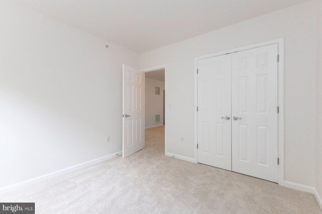 1859 Cedar Cove Way Unit 201, Woodbridge, VA 22191 - unfurnished bedroom featuring light colored carpet, a closet, and baseboards