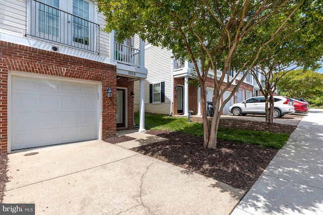 1859 Cedar Cove Way Unit 201, Woodbridge, VA 22191 - view of front of house featuring brick siding, driveway, and an attached garage