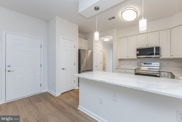 1859 Cedar Cove Way Unit 201, Woodbridge, VA 22191 - kitchen featuring appliances with stainless steel finishes, light stone countertops, light wood-type flooring, white cabinets, and a peninsula