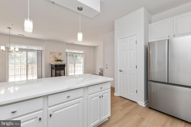 1859 Cedar Cove Way Unit 201, Woodbridge, VA 22191 - kitchen featuring freestanding refrigerator, light wood-type flooring, white cabinets, and light stone counters