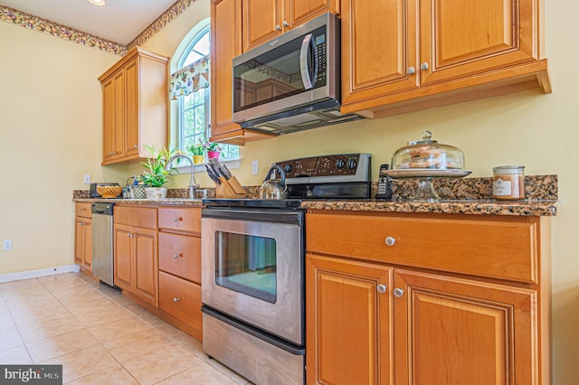137 Keller Way, Mays Landing, NJ 08330 - kitchen featuring appliances with stainless steel finishes, dark stone counters, light tile patterned floors, a sink, and baseboards