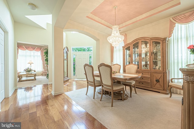 137 Keller Way, Mays Landing, NJ 08330 - dining area featuring arched walkways, light wood finished floors, a chandelier, ornamental molding, and a raised ceiling