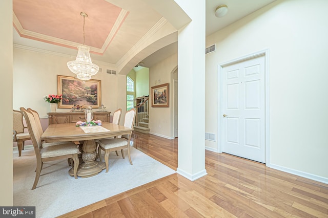 137 Keller Way, Mays Landing, NJ 08330 - dining space featuring arched walkways, light wood-style flooring, ornamental molding, a chandelier, and a raised ceiling