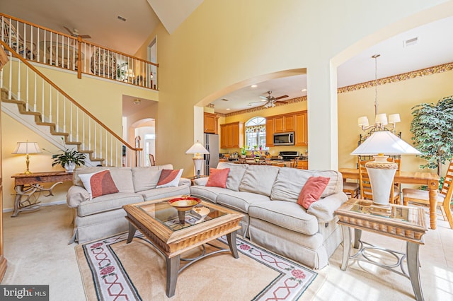 137 Keller Way, Mays Landing, NJ 08330 - living room featuring arched walkways, ceiling fan, stairway, a towering ceiling, and a chandelier